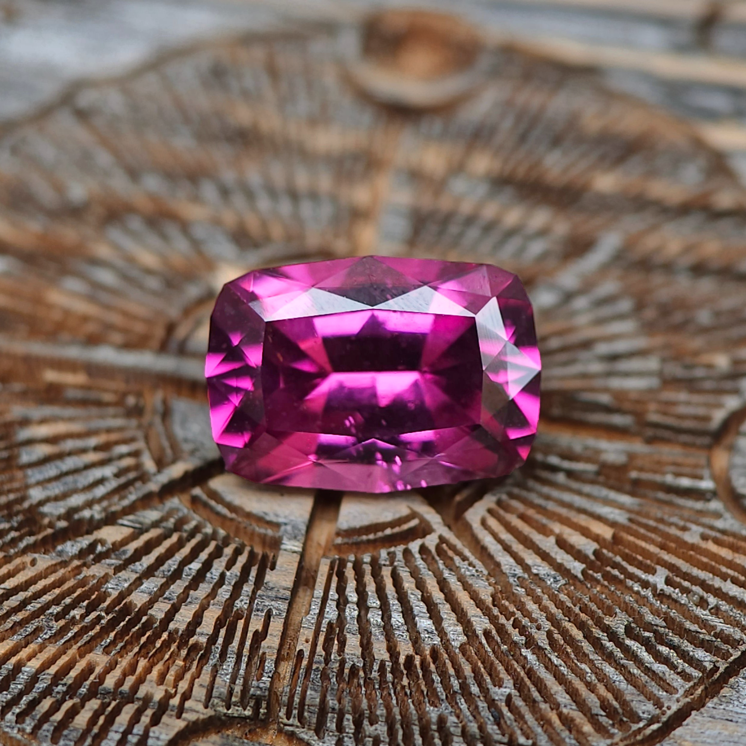 Ethically sourced garnets — vivid orange, green, and red tones — untreated stones full of brilliance.