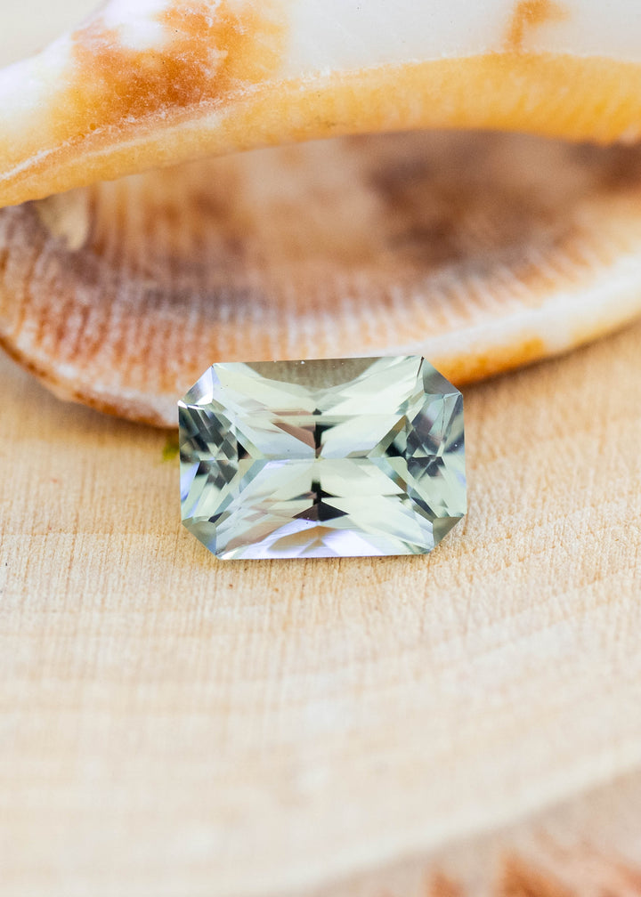 Natural 0.695 carat untreated Montana sapphire displaying soft seafoam green color in a precision radiant cut.