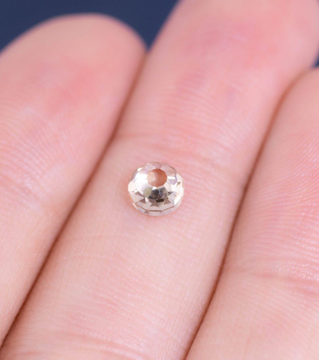 0.83ct Fancy Light Brown C2 VVS1 Mughal Cut Diamond displayed on fingertips in a hand-shot macro, highlighting intricate antique faceting and natural brilliance, South African origin.