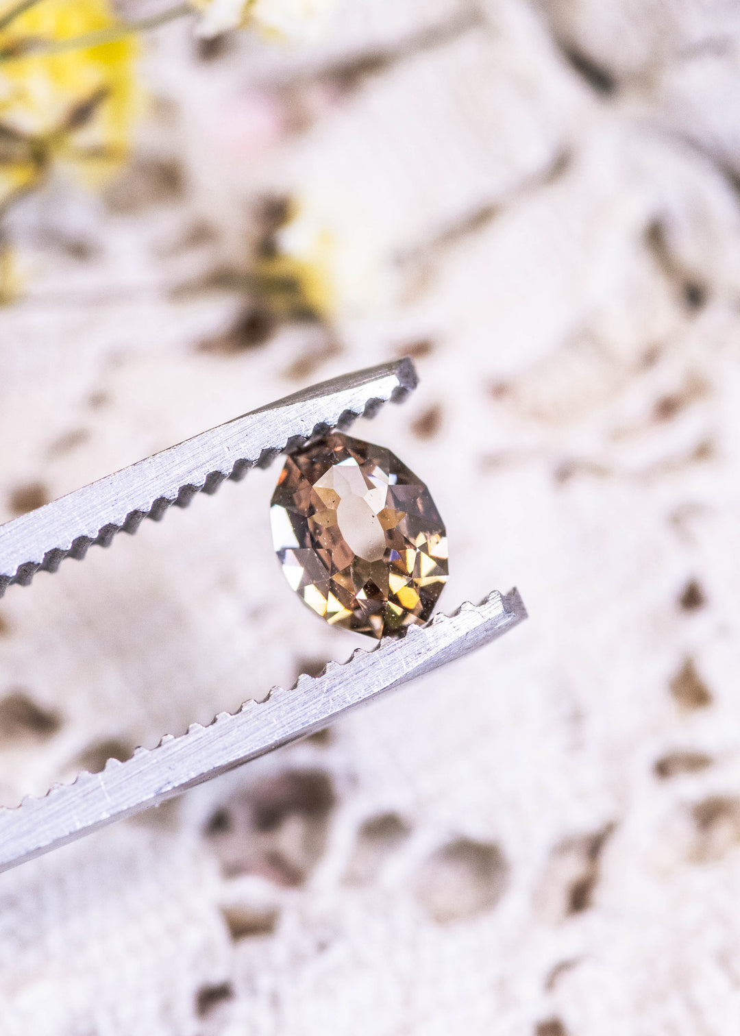 Loose champagne fancy light brown Mughal cut diamond held in tweezers, highlighting its faceted dome and distinctive antique-inspired design.