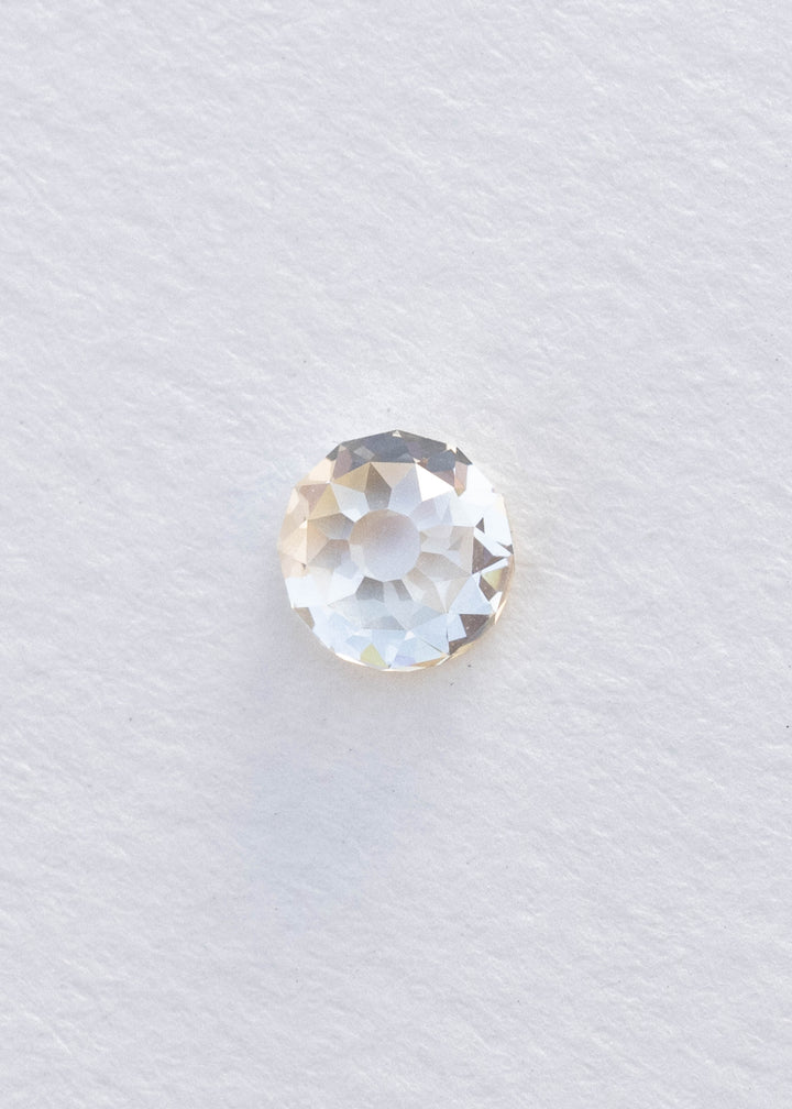 Face-up 0.99 carat round Mughal cut South African diamond on white, clearly showing its broad central table and individually shaped antique-style facets.