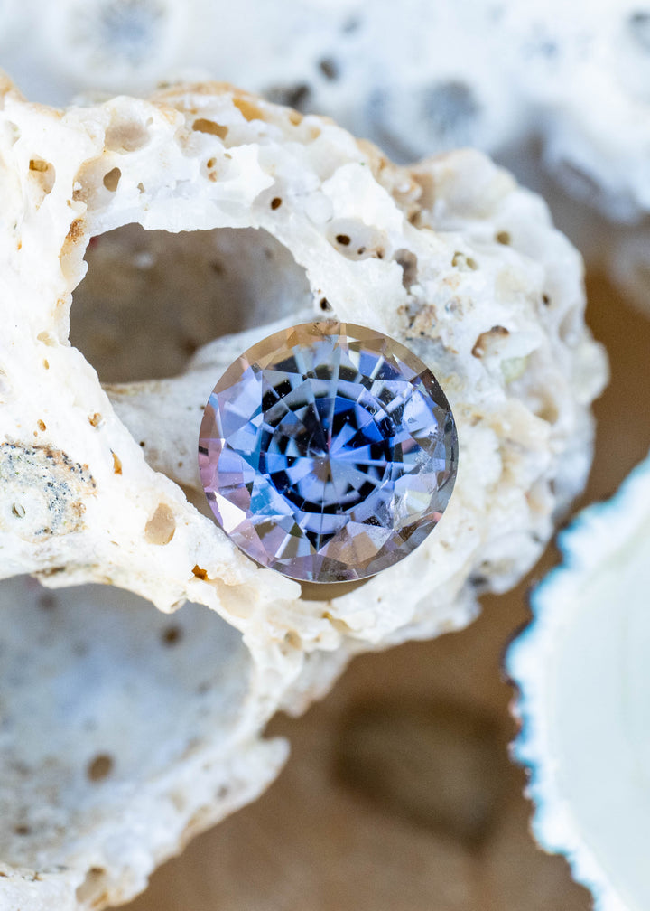Natural 1.72 carat untreated Merelani Hills tanzanite with a custom round mixed cut displaying blue, purple, teal, green, and warm orange color shifts.