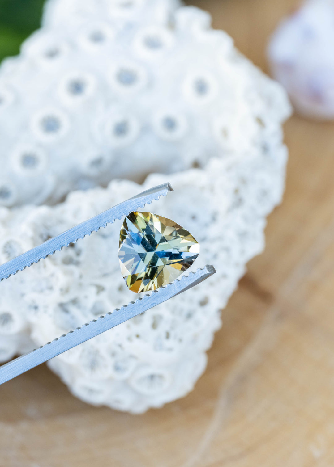Close-up of a natural untreated 1.81 carat custom brilliant trillion cut tanzanite revealing vibrant teal, green and golden yellow pleochroic color.