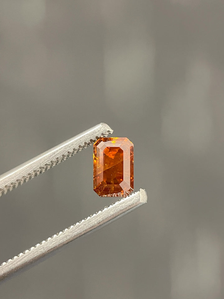 Close-up image of a 1.02-carat cognac diamond with a deep brown-orange hue. Expertly cut in an emerald step-cut shape, this gemstone showcases its rich color and clarity.