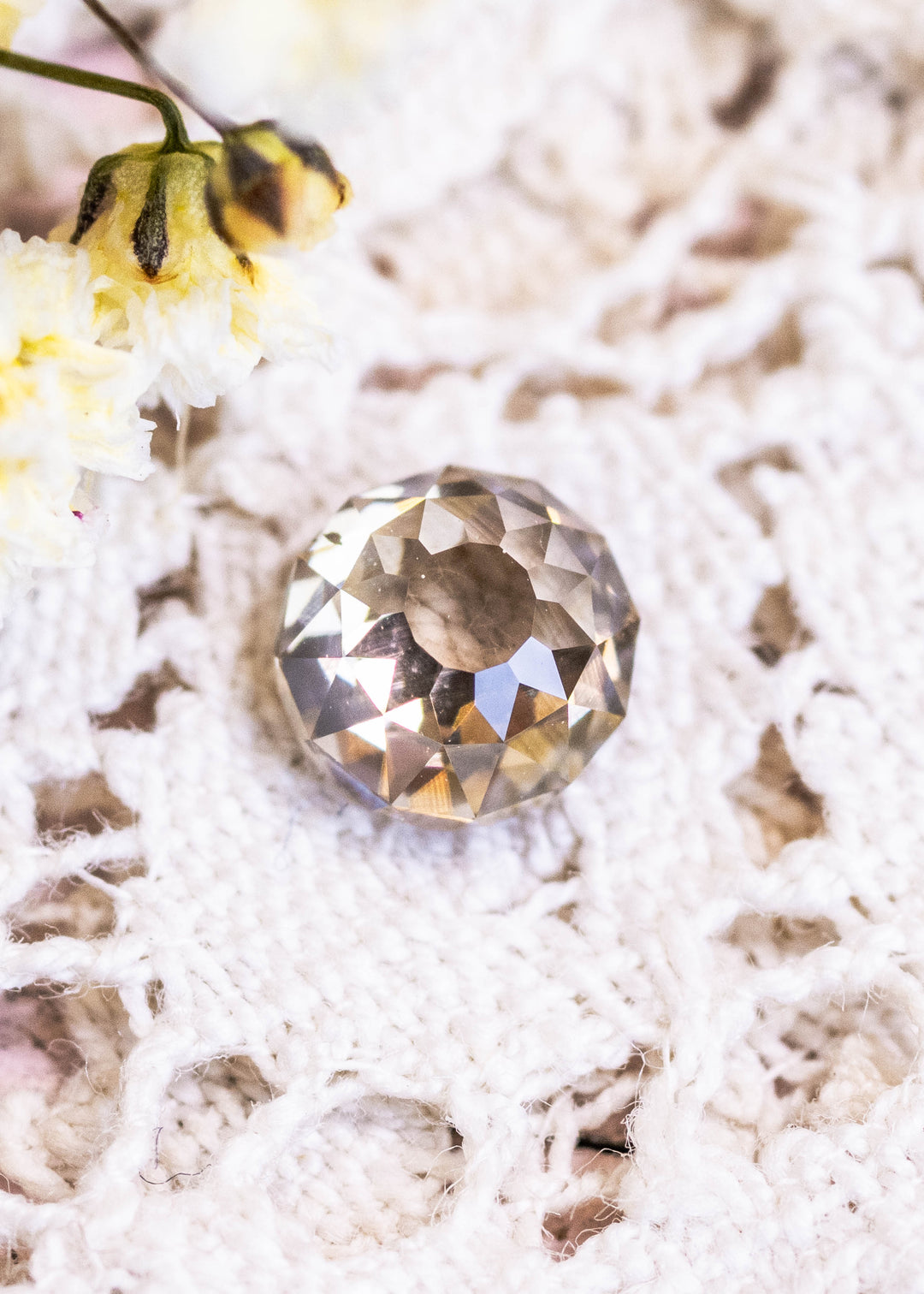 1.04ct South African Mughal diamond with fancy yellow brown tones photographed on lace background
