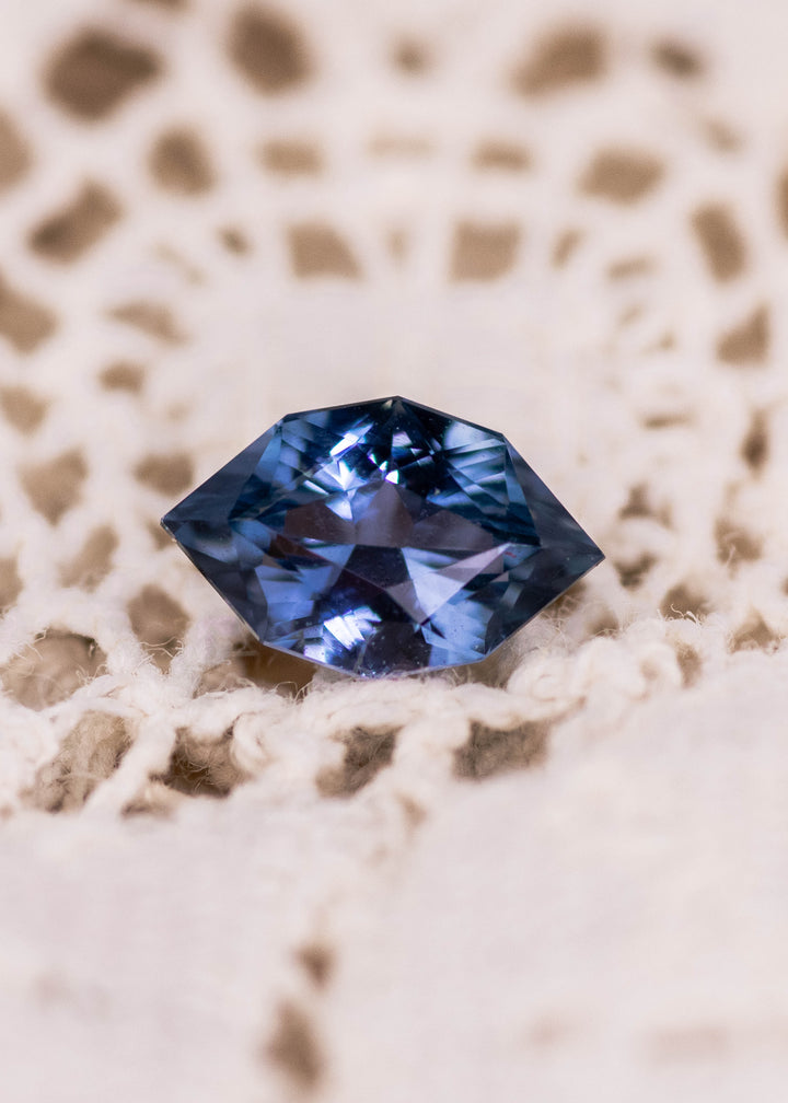 Loose 1.06 carat denim blue sapphire from Sakaraha, Madagascar shown face-up, displaying the modified brilliant marquise cut and deep blue tone.
