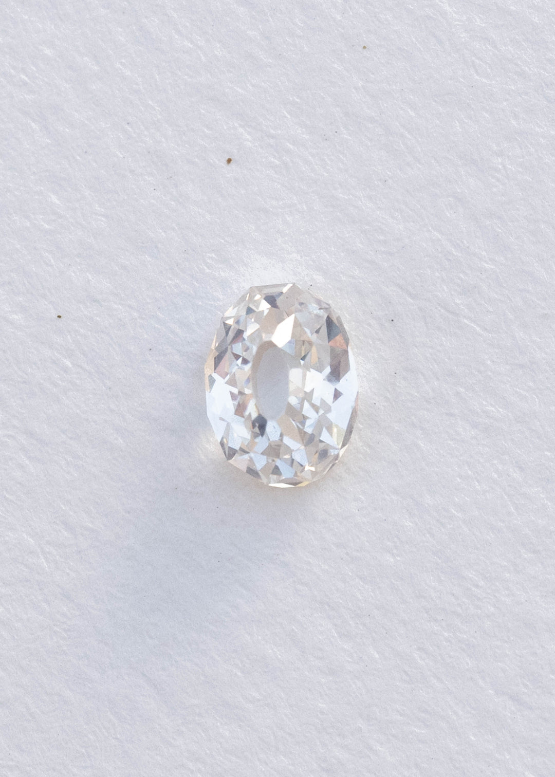 Face-up 1.11 carat oval Mughal cut diamond on white, clearly showing the elongated central table and irregular geometric facets surrounding it.