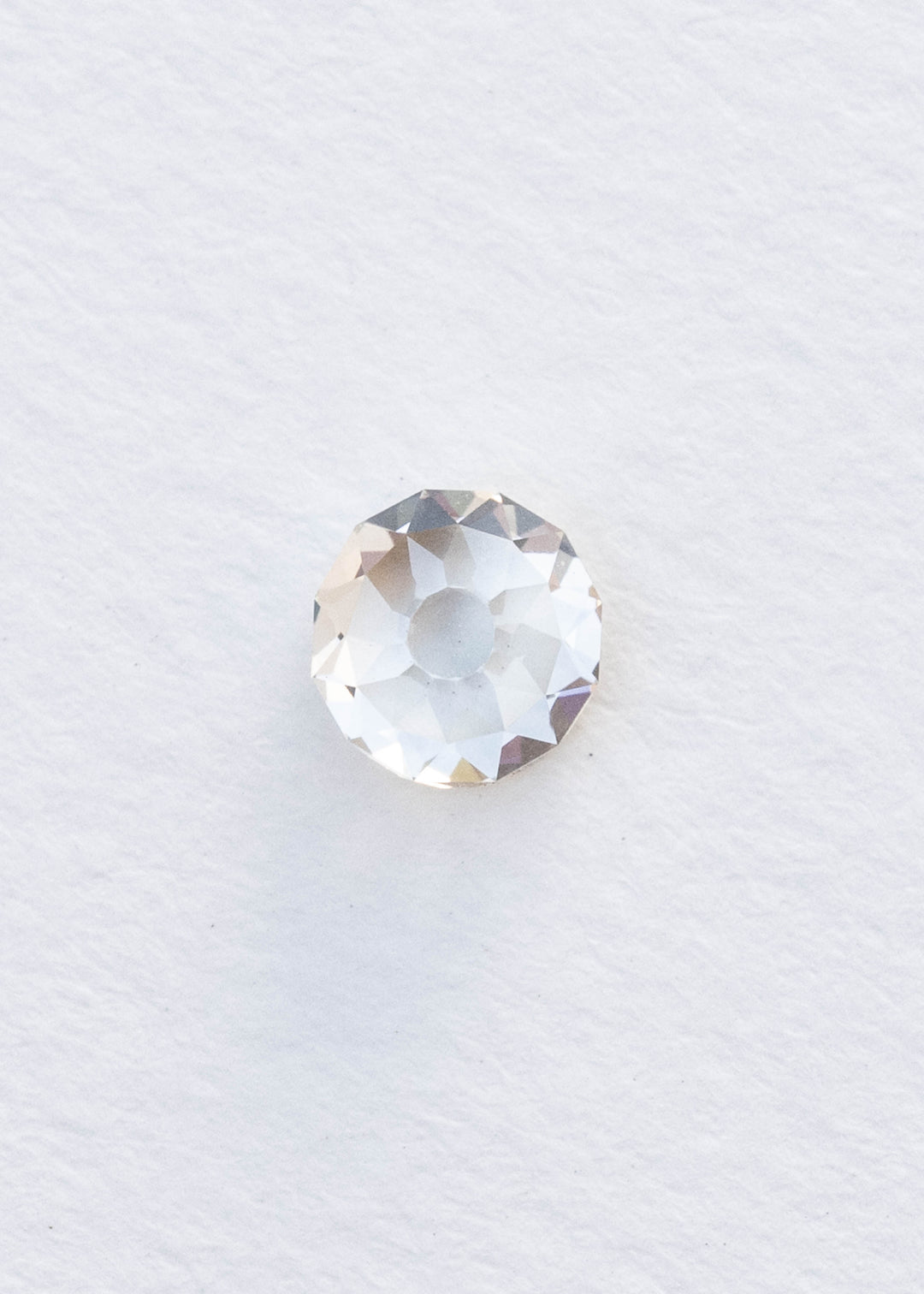 Face-up 1.11 carat round Mughal cut diamond photographed on white, clearly showing the broad central table and irregular geometric facet arrangement.