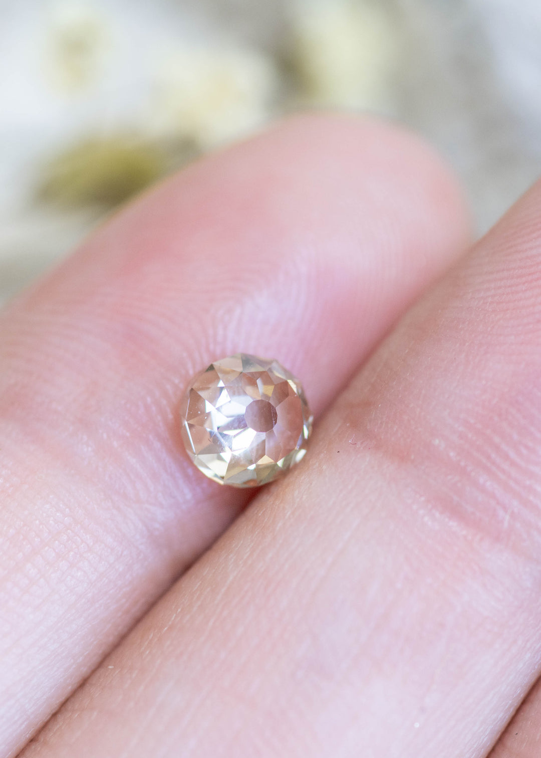 Loose 1.15 carat fancy light brown champagne diamond resting on fingertips, highlighting the Mughal cut and soft warm brilliance.