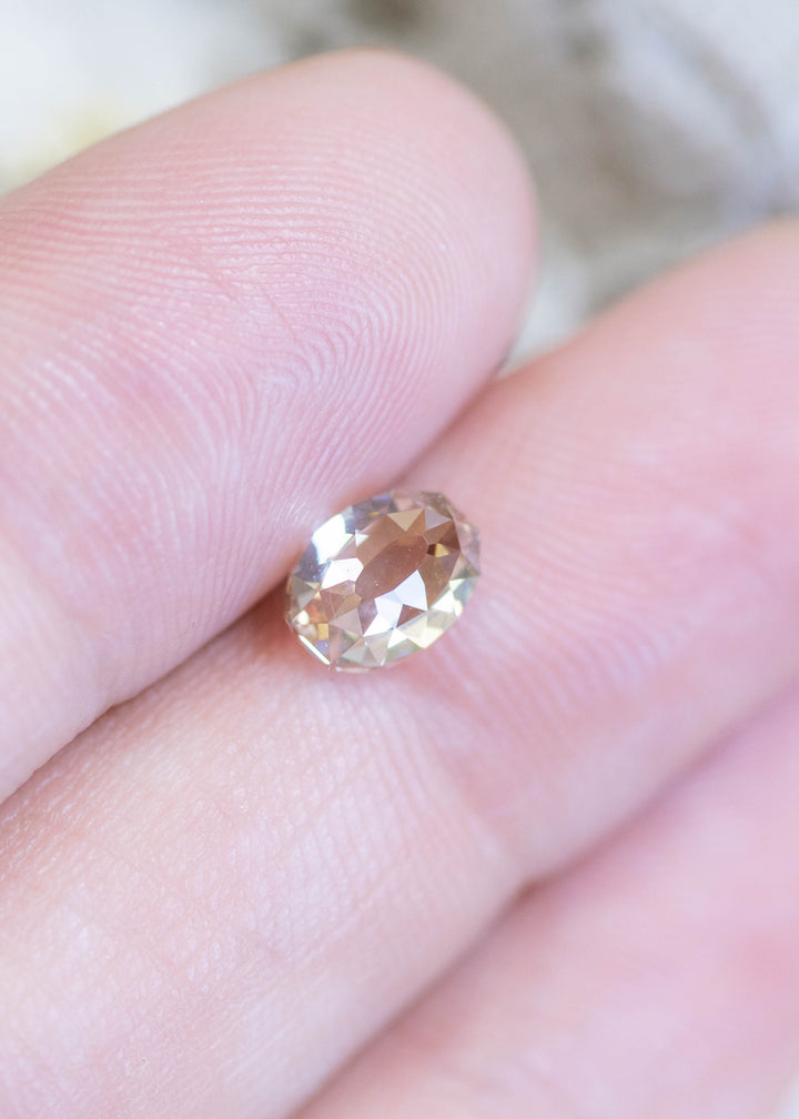 Loose 1.18 carat champagne fancy light brown Mughal cut diamond from South Africa resting on fingertips, showing scale, clarity, and natural warm brilliance.