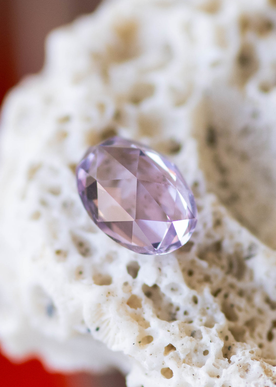 1.18 carat lavender pink sapphire shown face-up, displaying a precision oval rose cut and soft pastel color from Sakaraha, Madagascar.