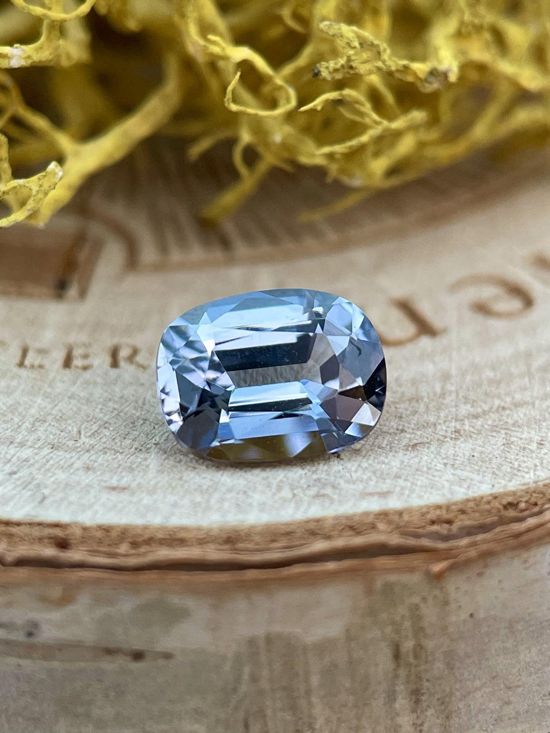 Close-up of a 1.36-carat Tanzanite gemstone in a modified cushion cut, displaying stunning teal, blue, and violet hues from Merelani Hills, Tanzania.
