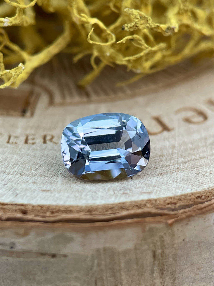 Close-up of a 1.36-carat Tanzanite gemstone in a modified cushion cut, displaying stunning teal, blue, and violet hues from Merelani Hills, Tanzania.