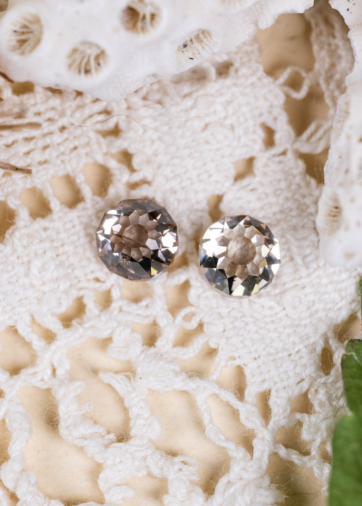 A matched pair of 1.37ct total weight Round Mughal cut diamonds from South Africa, photographed on ivory vintage lace. Their C3–C4 champagne coloration, VVS2 clarity, and distinctive geometric faceting create an elegant antique-inspired appearance.