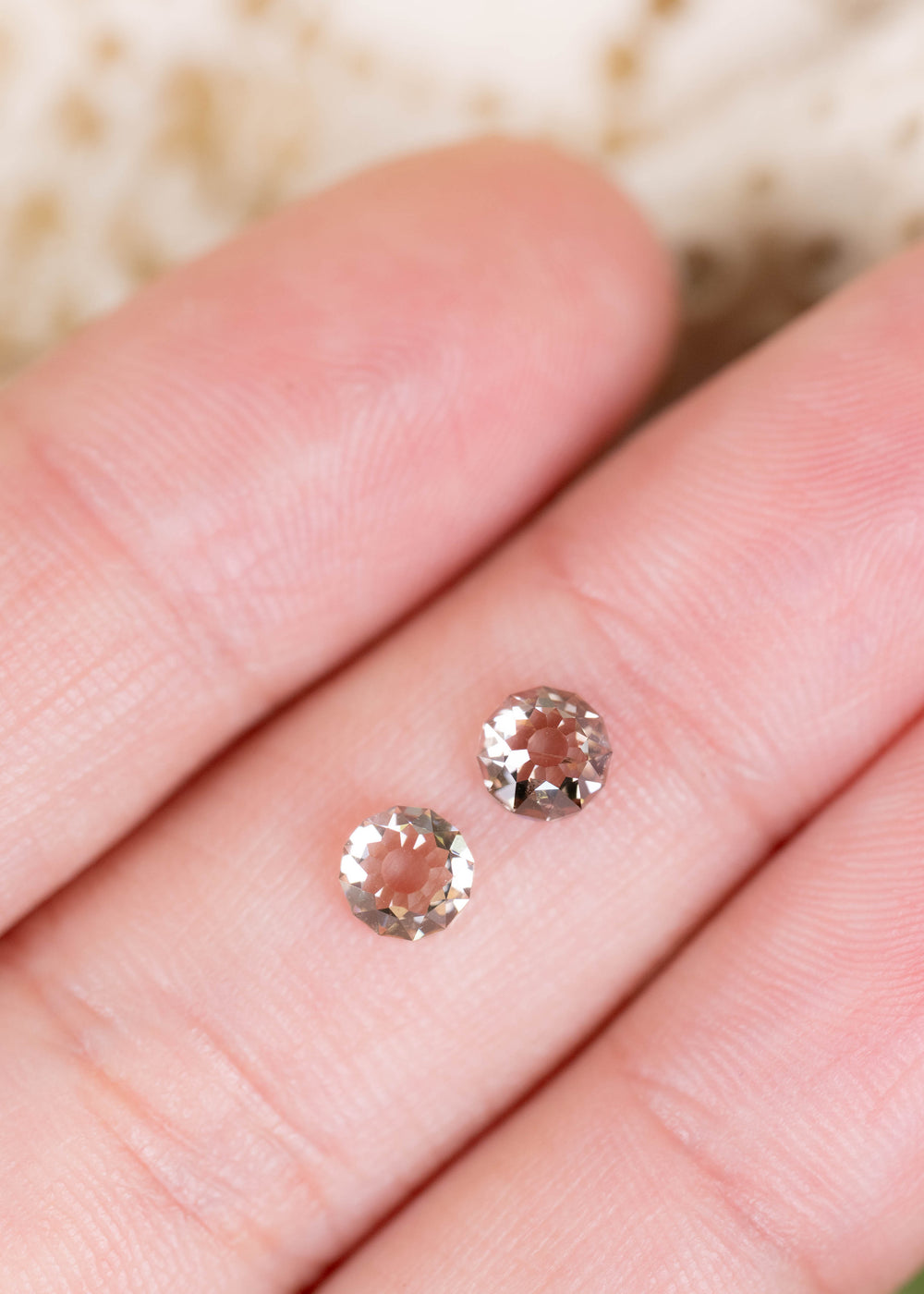A pair of South African Round Mughal cut diamonds weighing 1.37 carats total, photographed on fingers for scale. Their closely matched proportions and warm champagne tones make them suitable for custom diamond earrings and bespoke fine jewelry.