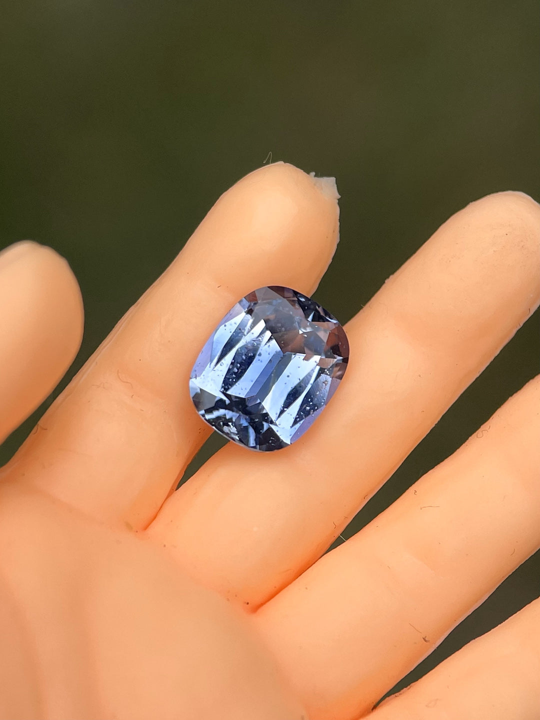 Close-up of a 1.48-carat denim blue and cornflower cushion-cut sapphire from Sri Lanka, showcasing its unique modified cushion cut with no treatments.