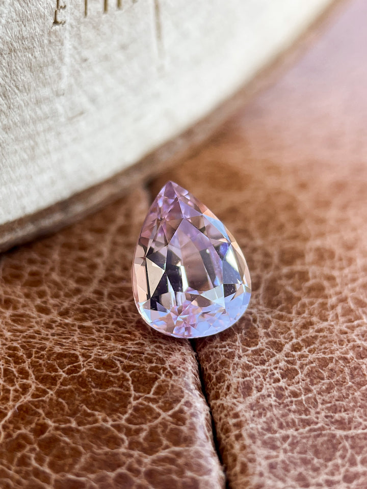 A close-up of a 1.68-carat pastel purple sapphire in a pear shape, showcasing its soft and elegant pastel hues. Originating from Sri Lanka and untreated.