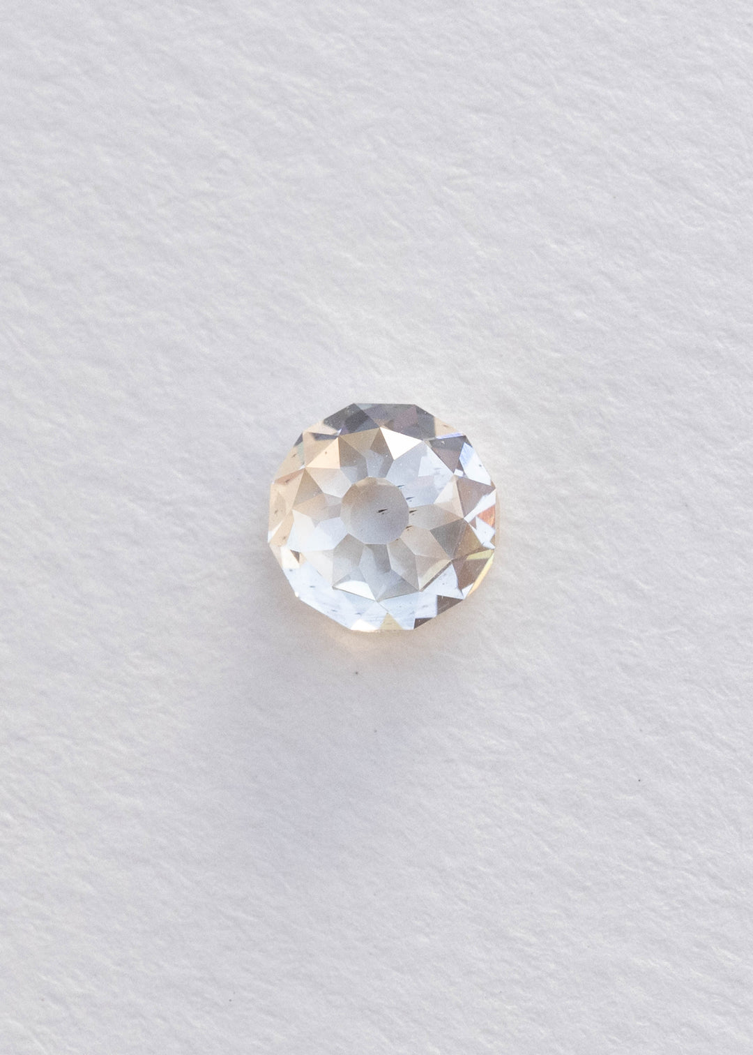 Face-up 1.68 carat Mughal cut diamond on a white background, clearly showing its rounded outline, central table and distinctive radial facet pattern.