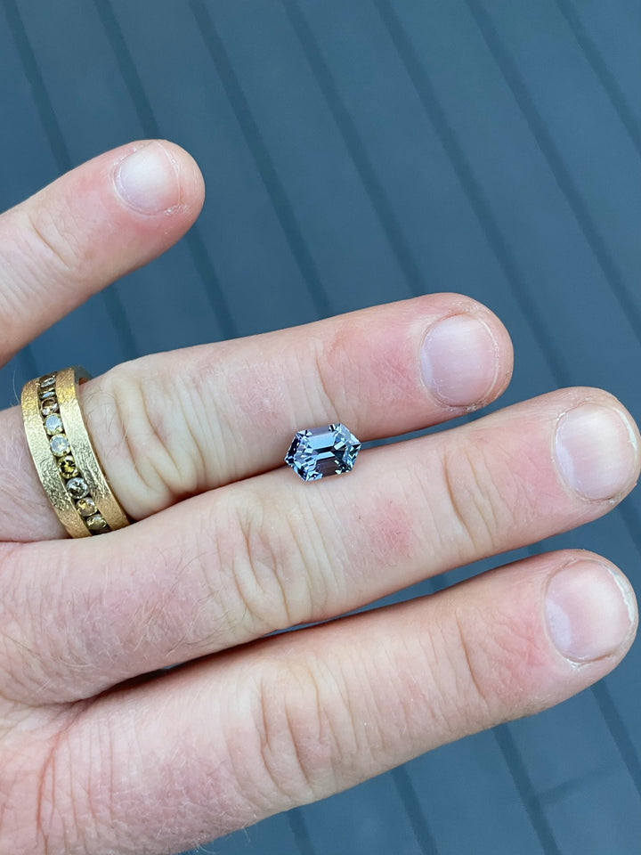 Hexagonal step-cut Tanzanite gemstone weighing 2.08 carats, displaying a mermaid color palette of teal, violet, and blue with exceptional clarity and brilliance.