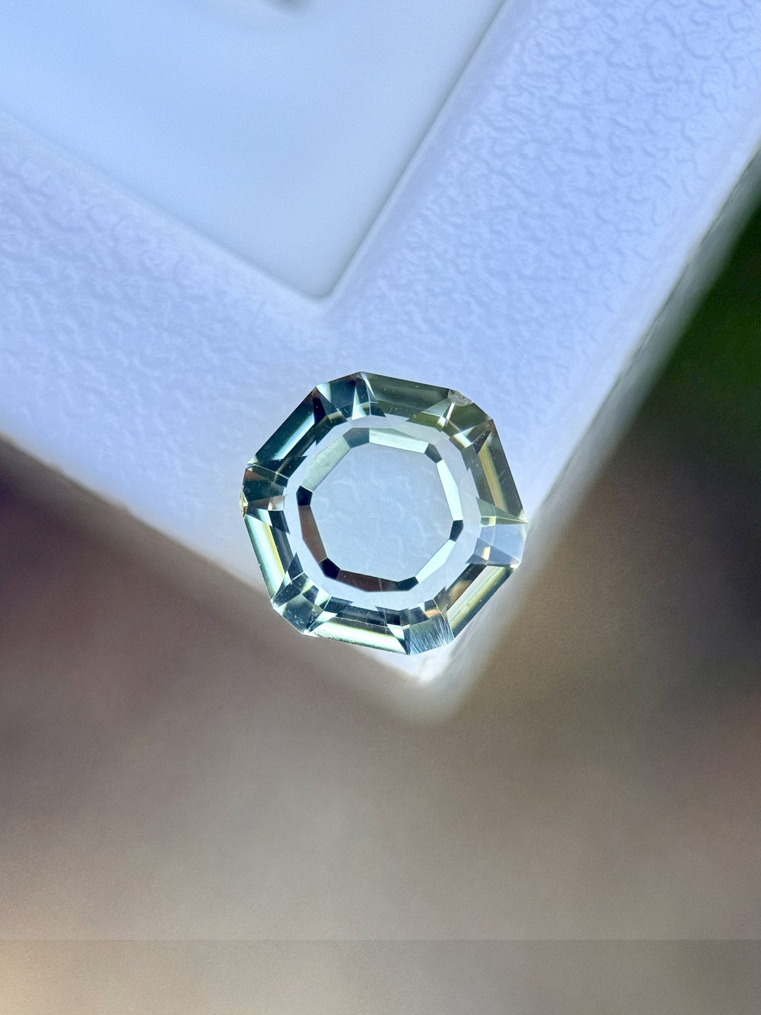 Top-down view of 2.09ct Montana hexagon sapphire with soft teal tones and precision faceting.