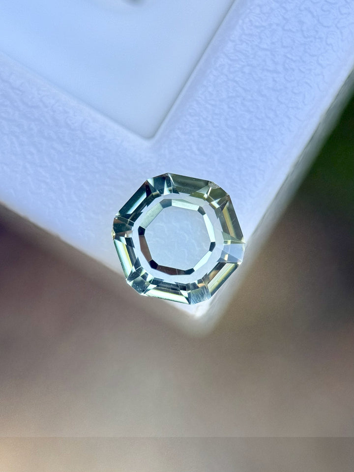 Top-down view of 2.09ct Montana hexagon sapphire with soft teal tones and precision faceting.