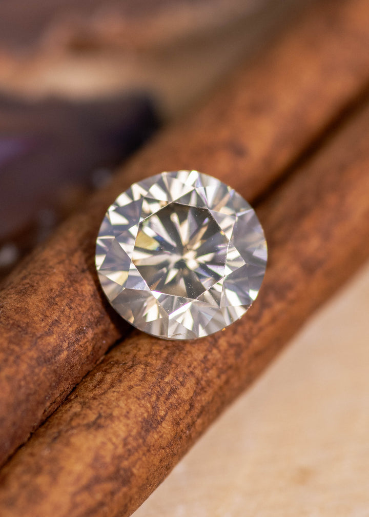 Close-up of 2.25ct fancy yellow brown champagne diamond showing high clarity VVS1 and detailed facet reflections.