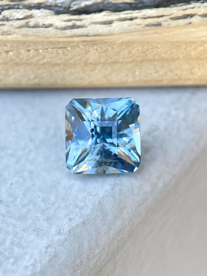 A stunning 2.49-carat natural Montana sapphire with a cushion cut, displaying vibrant blue and teal hues, ethically sourced from the El Dorado Bar Deposit, USA.