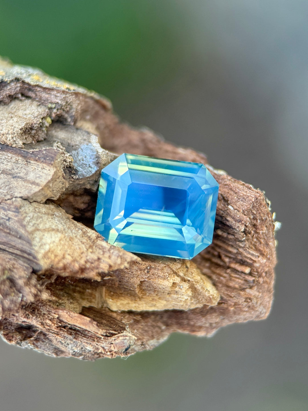 2.58 carat opalescent yellow teal blue green sapphire shown face-up, displaying natural color zoning and luminous pastel tones from Diego, Madagascar.
