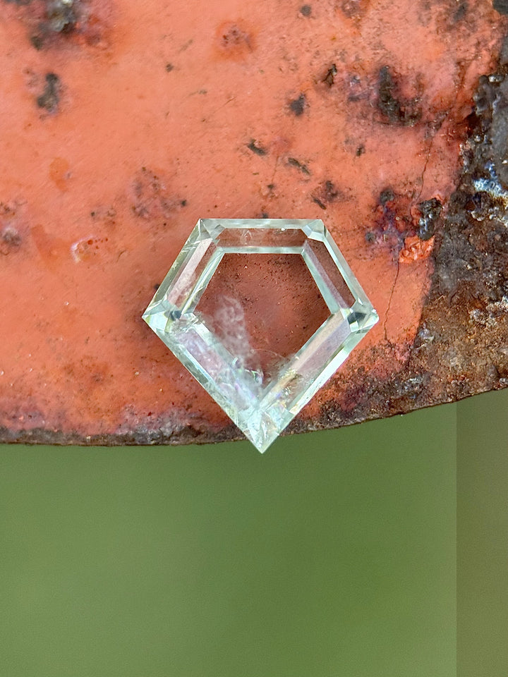 2.81-carat shield portrait cut sapphire from Montana in mint green seafoam hues on natural stone background