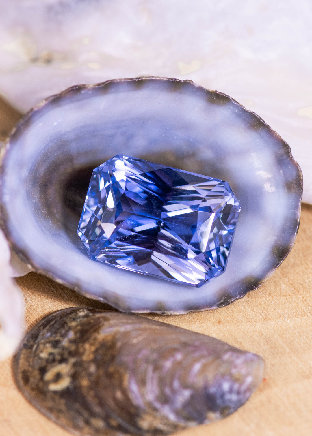 Loose blue to violet color shift sapphire from Sakaraha, Madagascar shown face-up in a custom mix cut radiant, displaying crisp facet lines and strong internal brilliance.