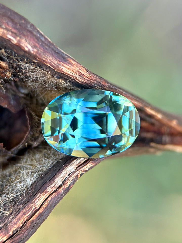 4.24 carat parti green teal blue sapphire shown face-up, displaying precision oval mixed cut faceting and vibrant natural color zoning from Diego, Madagascar.