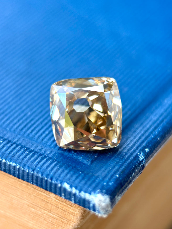 5.21 carat Fancy Deep Brown Champagne Diamond photographed in macro detail, showcasing antique old mine cushion faceting, rich cognac color, and exceptional VVS1 clarity from Canada's Ekati Diamond Mine.