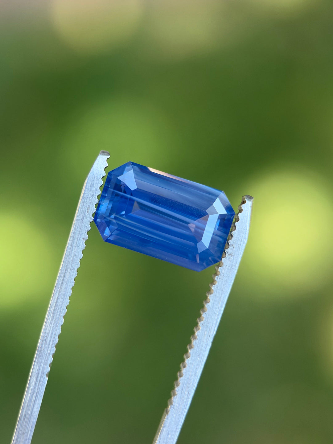Natural light view of a 5.30 carat banded blue sapphire from Ratnapura, Sri Lanka with vivid blue step facets