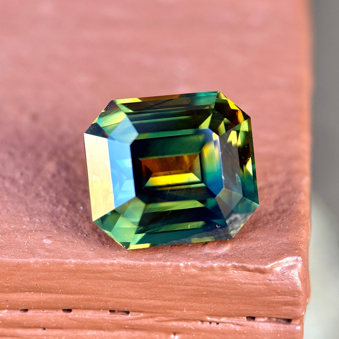 Multicolored gemstone on a wooden surface