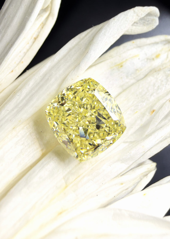 A 1.00-carat Fancy Light Yellow cushion cut diamond with VS1 clarity, offered as a loose diamond for custom engagement rings and fine jewelry.