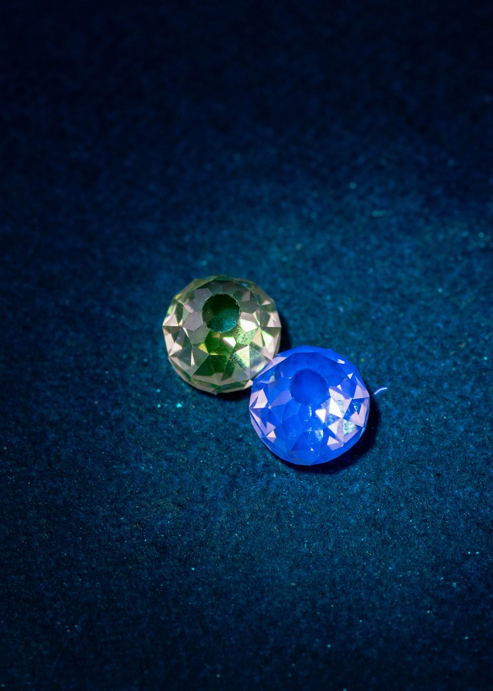 Fancy brown Mughal cut diamond pair under UV light showing light blue and yellow fluorescence, highlighting antique faceting, VVS1 clarity, and natural untreated diamonds from South Africa.