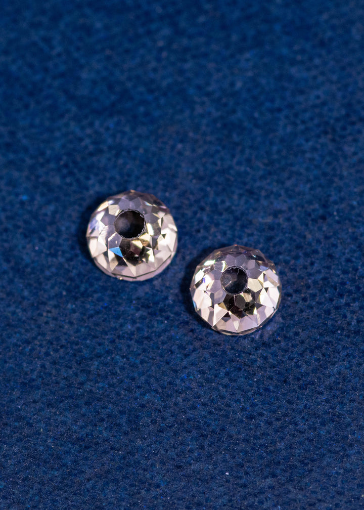 Pair of natural Mughal cut diamonds totaling 1.27 carats in fancy brown color, photographed side by side on deep blue fabric to highlight antique faceting, VVS clarity, and historic Mughal diamond cutting style from South Africa.