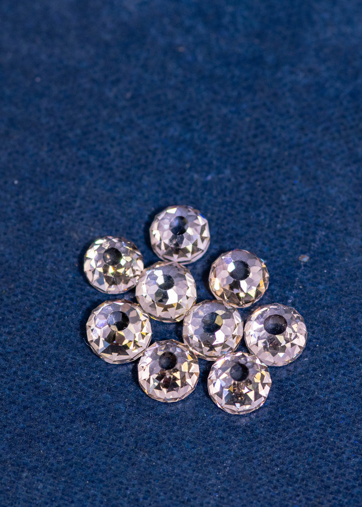 Five-point-one-one carat Mughal cut diamond parcel photographed on deep blue fabric, showcasing nine fancy light brown VVS diamonds with antique faceting and visible open culets from South Africa