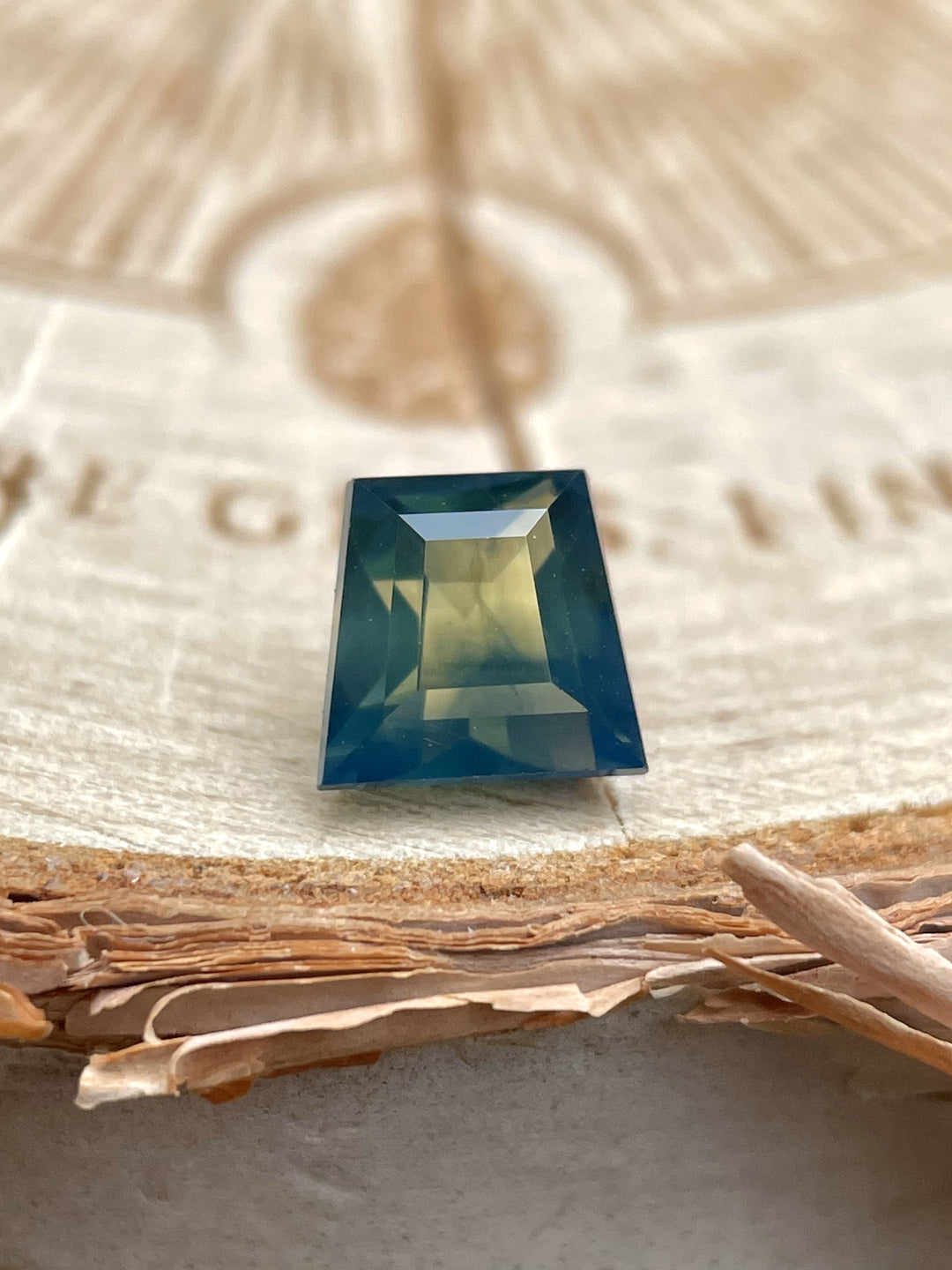 Close-up of 1.15ct untreated sapphire from Australia with geometric baguette cut and vivid natural coloration