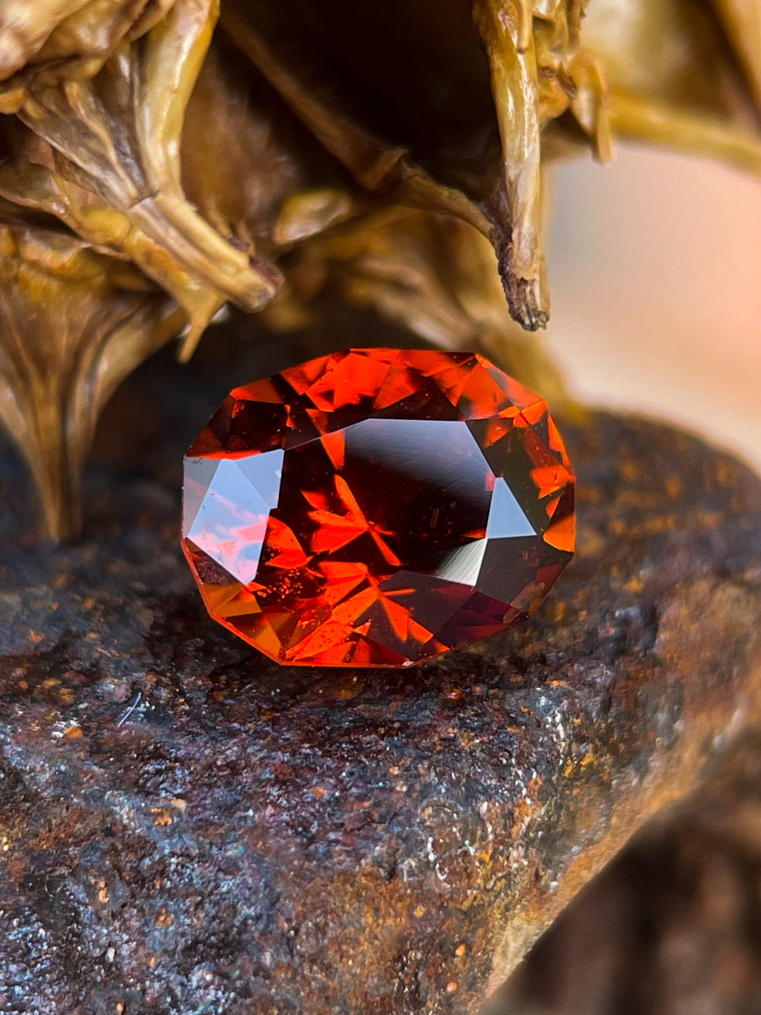 Hessonite Garnet gemstone, 1.68 carats, showcasing vibrant red-orange hues in a geometric brilliant oval cut, Kenyan origin.