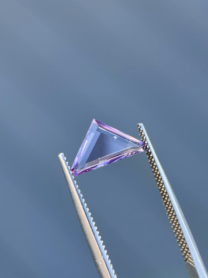 A bubble gum lavender Spinel gemstone, 1.02 carats, displayed in a modified trillion portrait cut against a light background.
