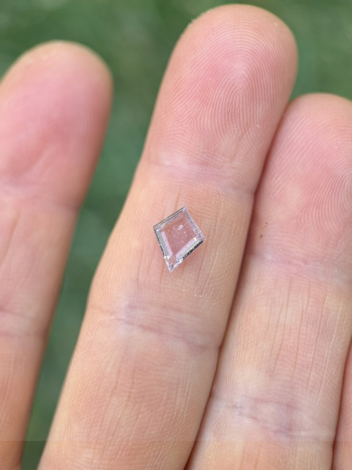 Colombian pastel sapphire weighing 0.97ct, photographed in macro view to highlight crisp kite silhouette and delicate color blend.