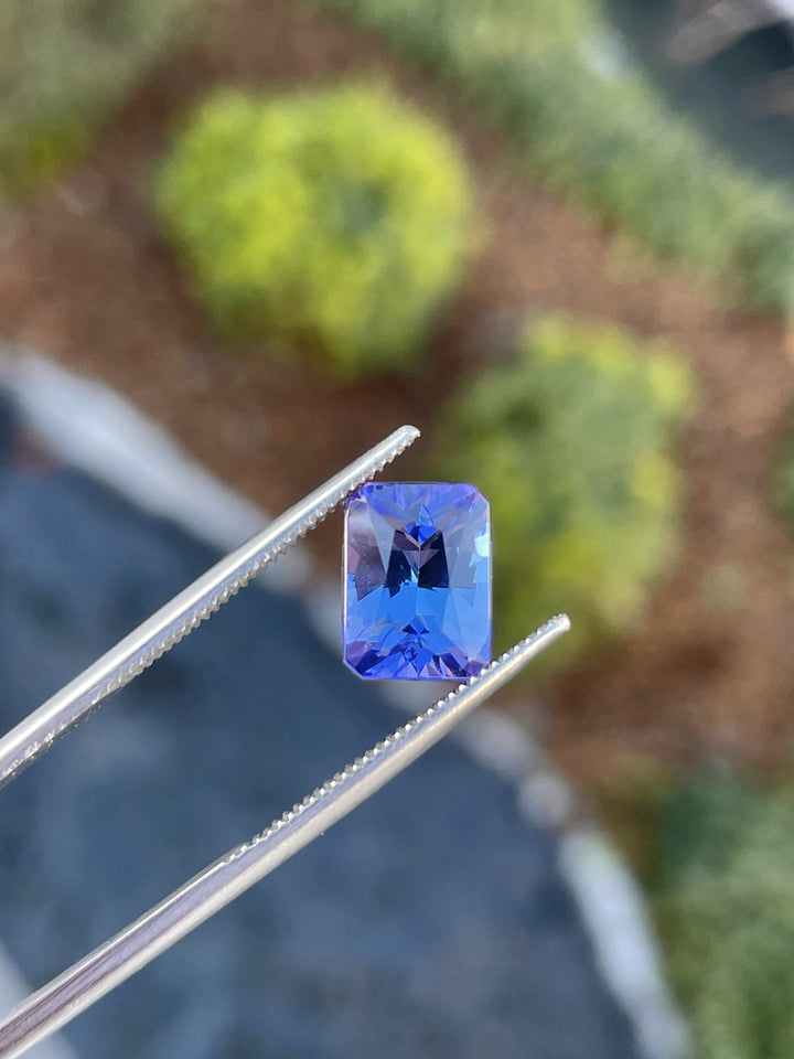 A custom radiant cut 3.57-carat tanzanite gemstone with vivid blue and ultra violet colors.