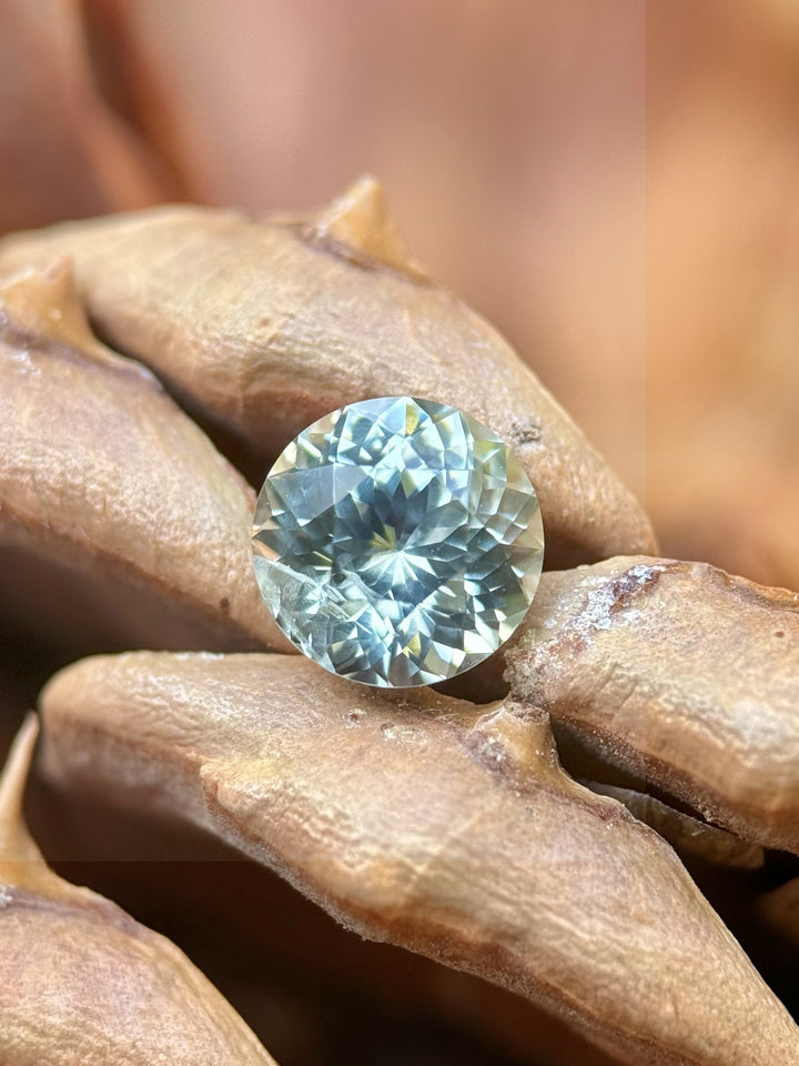 1.59ct earthy mint green Montana sapphire in hand, Portuguese cut with natural sparkle