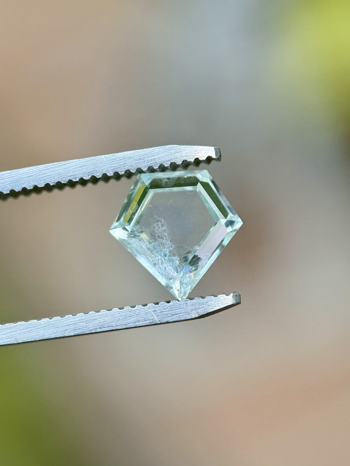 Heated 2.81ct El Dorado Bar sapphire showing seafoam and mint coloration in custom shield portrait cut