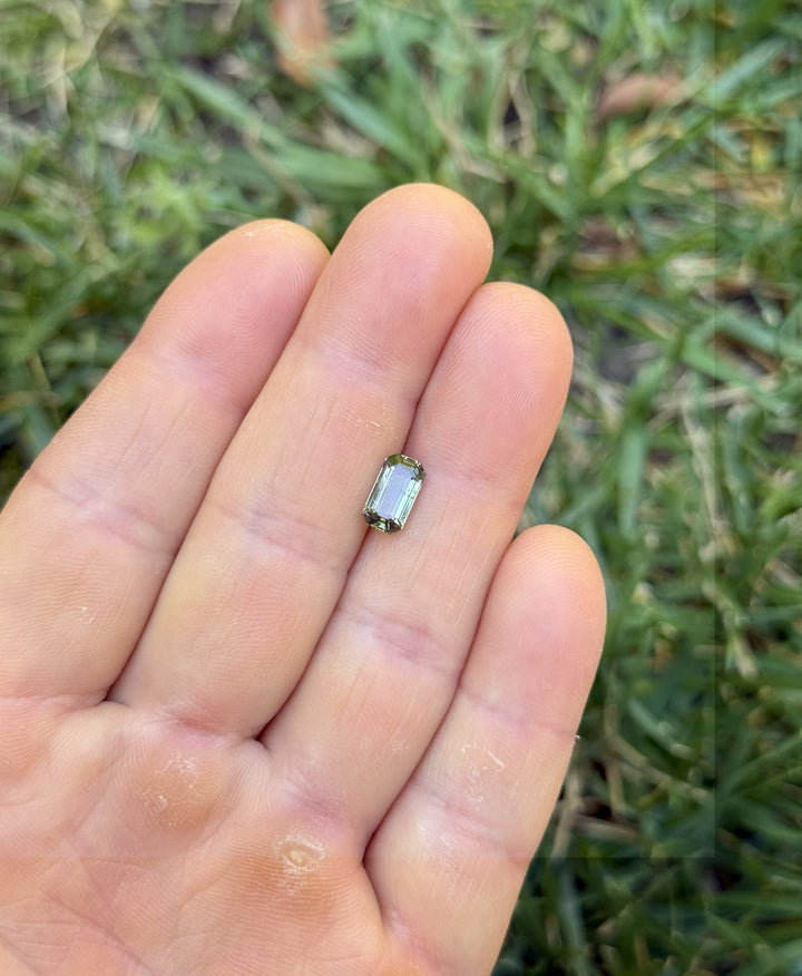 Angled view of 1.80 carat teal green sapphire from Umba River, Tanzania with sharp step facets and natural green tones