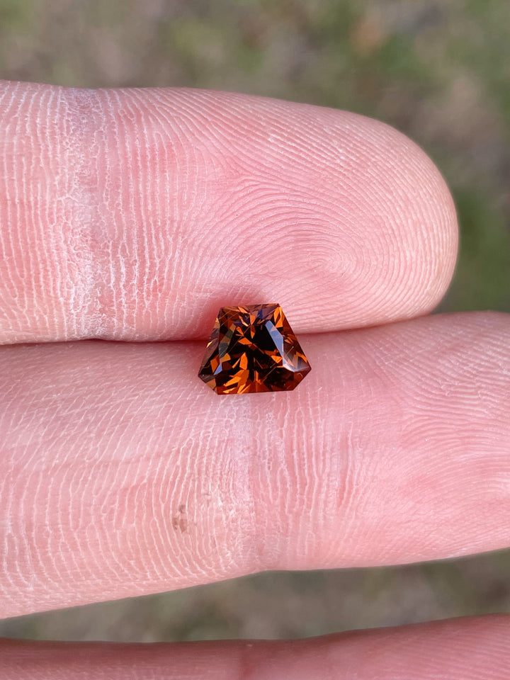 Hessonite Garnet featuring a 2.00-carat Custom Geometric Shield Cut, showcasing warm yellow, orange, and brown tones, ethically sourced from Kenya.