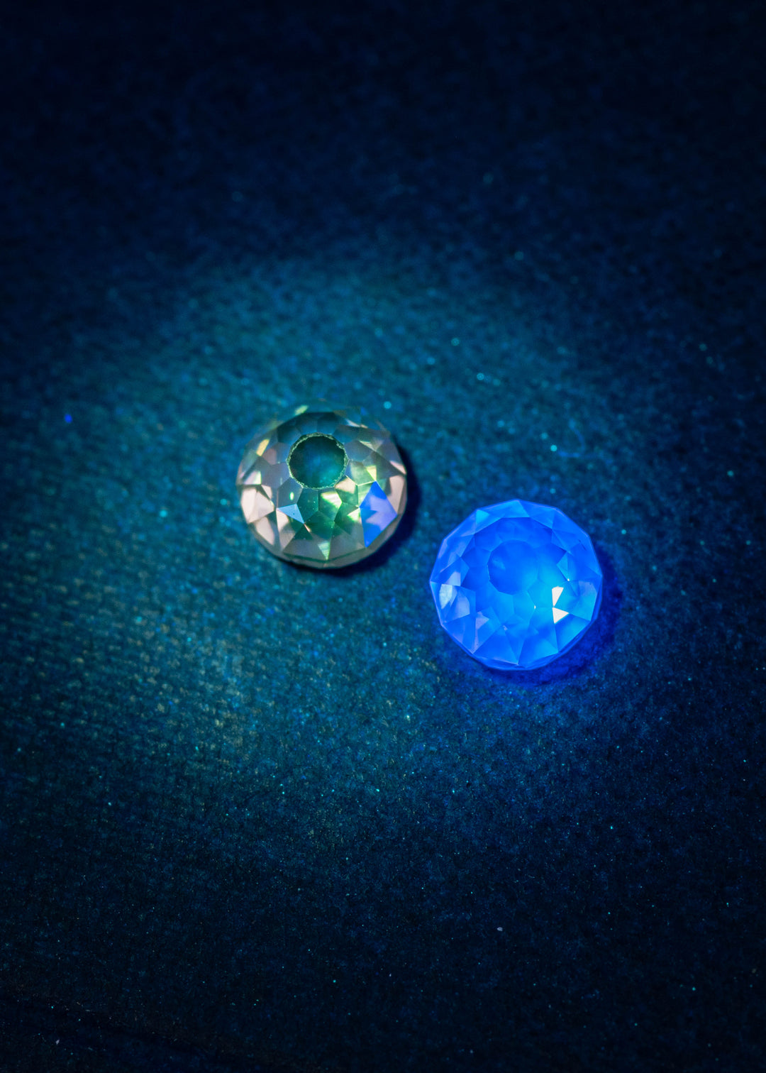 Matching Mughal cut diamond pair under UV light, showing very strong blue and yellow fluorescence in fancy brown diamonds, revealing natural fluorescence patterns and antique faceting contrast.