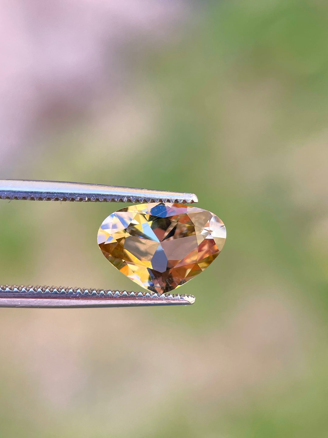 High-Resolution Image of a Wide Pear Brilliant Cut Tanzanite Gemstone Featuring Teal, Gold, and Yellow Colors, Weighing 2.48 Carats, with Dimensions 8.07 x 11.16 x 4.79 mm, Originating from Merelani Hills, Arusha Region, Tanzania - No Treatment