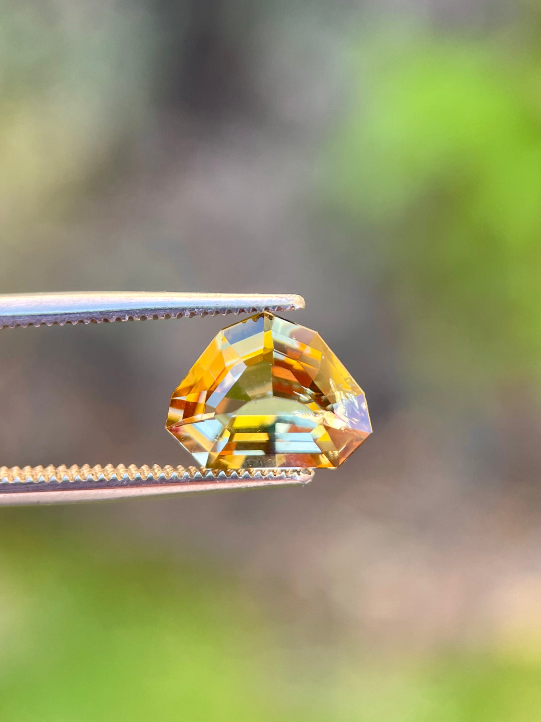 Exquisite 2.99 carat Tanzanite gemstone with a custom shield step cut, showcasing unique color transitions from slightly teal to peach and yellow, measuring 8.60 x 11.36 x 4.84 mm, untreated, from Merelani Hills, Tanzania, priced at $1,495.